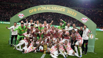Leipzig's players celebrate with the trophy after winning the penalty shootout and the the German Cup (DFB Pokal) final football match between SC Freiburg and RB Leipzig at the Olympic Stadium in Berlin on May 21, 2022. - - DFB REGULATIONS PROHIBIT ANY USE OF PHOTOGRAPHS AS IMAGE SEQUENCES AND QUASI-VIDEO. (Photo by THOMAS KIENZLE / AFP) / DFB REGULATIONS PROHIBIT ANY USE OF PHOTOGRAPHS AS IMAGE SEQUENCES AND QUASI-VIDEO. (Photo by THOMAS KIENZLE/AFP via Getty Images)