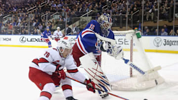 NEW YORK, NEW YORK - APRIL 26: Igor Shesterkin #31 of the New York Rangers shoots the puck away from Sebastian Aho #20 of the Carolina Hurricanes during the second period at Madison Square Garden on April 26, 2022 in New York City. The Hurrricanes defeated the Rangers 4-3. (Photo by Bruce Bennett/Getty Images)