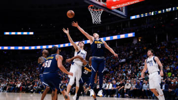 Denver Nuggets center Nikola Jokic (15) and Dallas Mavericks center Boban Marjanovic (51) battle for a rebound as guard P.J. Dozier (35) and forward Aaron Gordon (50) and forward Will Barton (5) defend and guard Luka Doncic (77) looks on in the third quarter at Ball Arena on 29 Oct. 2021. (Isaiah J. Downing-USA TODAY Sports)