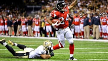 Oct 15, 2015; New Orleans, LA, USA; Atlanta Falcons running back Devonta Freeman (24) breaks a tackle by New Orleans Saints free safety Jairus Byrd (31) on a touchdown run during the fourth quarter of a game at the Mercedes-Benz Superdome. The Saints defeated the Falcons 31-21. Mandatory Credit: Derick E. Hingle-USA TODAY Sports