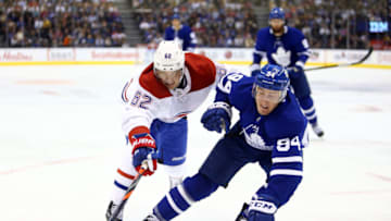 TORONTO, ON - OCTOBER 05: Artturi Lehkonen #62 of the Montreal Canadiens and Tyson Barrie #94 of the Toronto Maple Leafs chase the puck during an NHL game at Scotiabank Arena on October 5, 2019 in Toronto, Canada. (Photo by Vaughn Ridley/Getty Images)
