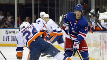 NEW YORK, NEW YORK - SEPTEMBER 24: Scott Mayfield #24 of the New York Islanders bounces off Vitali Kravtsov #74 of the New York Rangers during the first period at Madison Square Garden on September 24, 2019 in New York City. (Photo by Bruce Bennett/Getty Images)