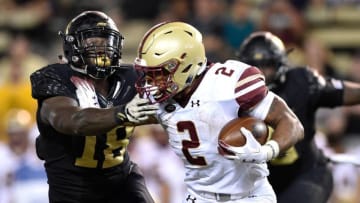 WINSTON SALEM, NC - SEPTEMBER 13: AJ Dillon #2 of the Boston College Eagles stiff-arms Carlos Basham Jr. #18 of the Wake Forest Demon Deacons during their game at BB&T Field on September 13, 2018 in Winston Salem, North Carolina. (Photo by Grant Halverson/Getty Images)