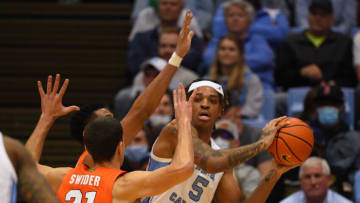Feb 28, 2022; Chapel Hill, North Carolina, USA; North Carolina Tar Heels forward Armando Bacot (5) looks to pass as Syracuse Orange forward Cole Swider (21) defends in the first half at Dean E. Smith Center. Mandatory Credit: Bob Donnan-USA TODAY Sports