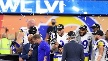 INGLEWOOD, CALIFORNIA - FEBRUARY 13: Matthew Stafford #9 of the Los Angeles Rams holds the Lombardi trophy celebrating with teammates after the Rams defeated the Cincinnati Bengals 23-20 in Super Bowl LVI at SoFi Stadium on February 13, 2022 in Inglewood, California. (Photo by Focus on Sport/Getty Images)