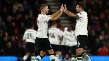 BOURNEMOUTH, ENGLAND - DECEMBER 17: Ragnar Klavan of Liverpool and teammate Dejan Lovren of Liverpool celebrate their teams first goal during the Premier League match between AFC Bournemouth and Liverpool at Vitality Stadium on December 17, 2017 in Bournemouth, England. (Photo by Bryn Lennon/Getty Images)