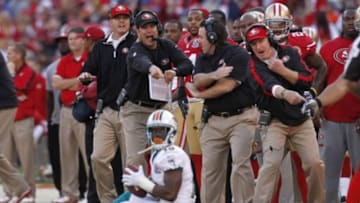 December 9, 2012; San Francisco, CA, USA; San Francisco 49ers head coach Jim Harbaugh reacts to a catch made by Miami Dolphins wide receiver Davone Bess (15) in the fourth quarter at Candlestick Park. The 49ers defeated the Dolphins 27-13. Mandatory Credit: Cary Edmondson-USA TODAY Sports