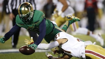 Nov 21, 2015; Boston, MA, USA; Boston College Eagles back Justin Simmons (27) fumbles the ball while defended by Notre Dame Fighting Irish cornerback Devin Butler (12) during the first quarter at Fenway Park. Mandatory Credit: Greg M. Cooper-USA TODAY Sports