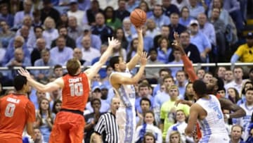 Jan 26, 2015; Chapel Hill, NC, USA; North Carolina Tar Heels guard Marcus Paige (5) shoots as Syracuse Orange guard Michael Gbinije (0) and s10#2/ and forward Rakeem Christmas (25) defend in the second half. The Tar Heels defeated the Orange 93-83 at Dean E. Smith Center. Mandatory Credit: Bob Donnan-USA TODAY Sports