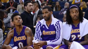December 21, 2013; Oakland, CA, USA; Los Angeles Lakers small forward Nick Young (0), power forward Shawne Williams (3, center), and center Jordan Hill (27, right) react on the bench during the fourth quarter against the Golden State Warriors at Oracle Arena. The Warriors defeated the Lakers 102-83. Mandatory Credit: Kyle Terada-USA TODAY Sports
