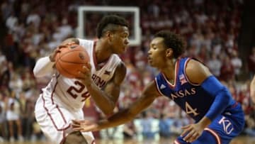 Feb 13, 2016; Norman, OK, USA; Oklahoma Sooners guard Buddy Hield (24) handles the ball against Kansas Jayhawks guard Devonte
