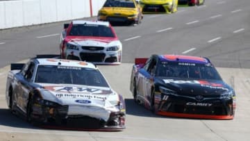 Mar 29, 2015; Martinsville, VA, USA; Sprint Cup Series driver Chris Buescher (34) and driver Denny Hamlin (11) during the STP 500 at Martinsville Speedway. Mandatory Credit: Randy Sartin-USA TODAY Sports