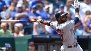 Jul 27, 2014; Kansas City, MO, USA; Cleveland Indians first basemen Carlos Santana (41) hits a two run home run against the Kansas City Royals during the fifth inning at Kauffman Stadium. Mandatory Credit: Peter G. Aiken-USA TODAY Sports