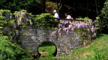 4 May 1997: Costantino Rocca of Italy and his caddy walk across the bridge at the eighth hole during the Italian Open at the Gardagolf Club in Brescia, Italy. Mandatory Credit: Andrew Redington/Allsport