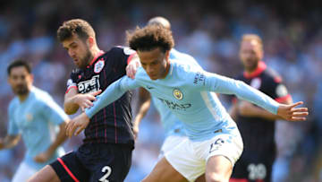 MANCHESTER, ENGLAND - MAY 06: Leroy Sane of Manchester City is challenged by Tommy Smith of Huddersfield Town during the Premier League match between Manchester City and Huddersfield Town at Etihad Stadium on May 6, 2018 in Manchester, England. (Photo by Laurence Griffiths/Getty Images)