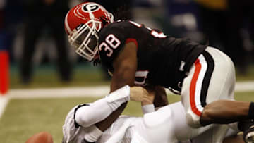 NEW ORLEANS - JANUARY 01: Quarterback Colt Brennan #15 of the Hawaii Warriors is sacked by Marcus Howard #38 of the Georgia Bulldogs on January 1, 2008 during the Allstate Sugar Bowl at the Louisiana Superdome on January 1, 2008 in New Orleans, Louisiana. The Bulldogs recovered the fumble for a touchdown and won 41-10. (Photo by Layne Murdoch/Getty Images)