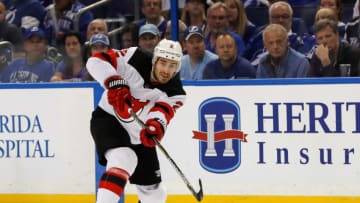 TAMPA, FL - APRIL 21: John Moore #2 of the New Jersey Devils shoots against the Tampa Bay Lightning in the first period of Game Five of the Eastern Conference First Round during the 2018 NHL Stanley Cup Playoffs at Amalie Arena on April 21, 2018 in Tampa, Florida. (Photo by Mike Carlson/Getty Images) *** Local Caption *** John Moore