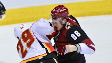 Dec 19, 2016; Glendale, AZ, USA; Arizona Coyotes left wing Jamie McGinn (88) and Calgary Flames defenseman Deryk Engelland (29) fight during the second period at Gila River Arena. Mandatory Credit: Matt Kartozian-USA TODAY Sports