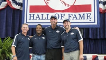 Jul 25, 2015; Cooperstown, NY, USA; Hall of Fame inductees Craig Biggio and Pedro Martinez and Randy Johnson and John Smoltz pose for pictures at the conclusion of the media press conference at National Baseball Hall of Fame. Mandatory Credit: Gregory J. Fisher-USA TODAY Sports
