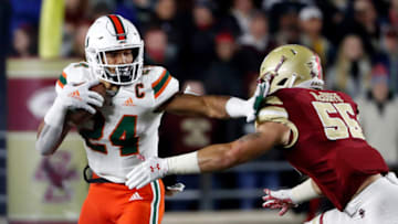 Oct 26, 2018; Chestnut Hill, MA, USA; Miami running back Travis Homer (24) tries to stiff arm Boston College linebacker Isaiah McDuffie (55) during the first half at Alumni Stadium. Mandatory Credit: Winslow Townson-USA TODAY Sports
