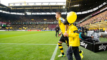 DORTMUND, GERMANY - AUGUST 23: Marco Reus (BVB) enters the pitch as team captain of Borussia Dortmund for the first time at the Bundesliga match between Borussia Dortmund and Bayer 04 Leverkusen at Signal Iduna Park on August 23, 2014 in Dortmund, Germany. (Photo by Alexandre Simoes/Borussia Dortmund/Getty Images)