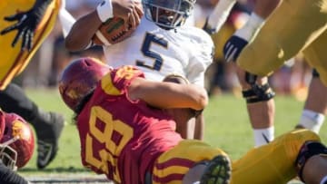 Nov 29, 2014; Los Angeles, CA, USA; Notre Dame Fighting Irish quarterback Everett Golson (5) is sacked by USC Trojans defensive end J.R. Tavai (58) in the second quarter at the Los Angeles Memorial Coliseum. Mandatory Credit: Matt Cashore-USA TODAY Sports