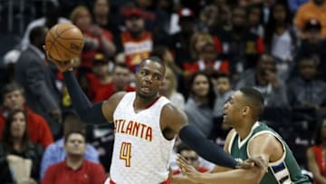 Mar 25, 2016; Atlanta, GA, USA; Atlanta Hawks forward Paul Millsap (4) makes a move against Milwaukee Bucks forward Jabari Parker (12) in the first quarter of their game at Philips Arena. Mandatory Credit: Jason Getz-USA TODAY Sports