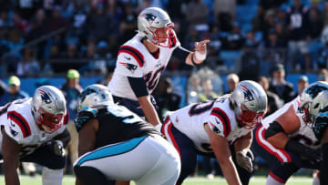 Auburn footballCHARLOTTE, NORTH CAROLINA - NOVEMBER 07: Mac Jones #10 of the New England Patriots under center during the second quarter against the Carolina Panthers at Bank of America Stadium on November 07, 2021 in Charlotte, North Carolina. (Photo by Grant Halverson/Getty Images)