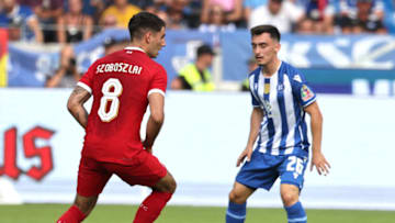 Liverpool's Hungarian midfielder Dominik Szoboszlai (L) and Karlsruhe's Paul Nebel vie for the ball during the pre-season friendly football match between Karlsruhe SC and Liverpool FC in Karlsruhe, western Germany, on July 19, 2023. (Photo by Daniel ROLAND / AFP) (Photo by DANIEL ROLAND/AFP via Getty Images)