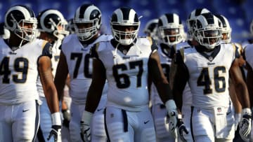 BALTIMORE, MD - AUGUST 09: Chunky Clements #67 of the Los Angeles Rams and teammates take the field for warmups before playing against the Baltimore Ravens during a preseason game at M&T Bank Stadium on August 9, 2018 in Baltimore, Maryland. (Photo by Patrick Smith/Getty Images)