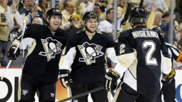 Apr 16, 2014; Pittsburgh, PA, USA; Pittsburgh Penguins left wing James Neal (left) and left wing Chris Kunitz (middle) react after defenseman Matt Niskanen (2) scored a goal against the Columbus Blue Jackets during the second period in game one of the first round of the 2014 Stanley Cup Playoffs at the CONSOL Energy Center. Mandatory Credit: Charles LeClaire-USA TODAY Sports