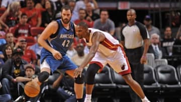 Dec 18, 2012; Miami, FL, USA; Minnesota Timberwolves power forward Kevin Love (42) and Miami Heat center Chris Bosh (1) chase a loose ball during the thrust half at the American Airlines Arena. Mandatory Credit: Steve Mitchell-USA TODAY Sports
