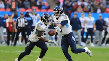 21st October 2018, Wembley Stadium, London, England; NFL in London, game two, Tennessee Titans versus Los Angeles Chargers; Quarterback Marcus Mariota of the Tennessee Titans hands off the ball to running back Dion Lewis (photo by Shaun Brooks/Action Plus via Getty Images)