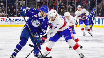 LAVAL, QC - DECEMBER 20: Syracuse Crunch center Anthony Cirelli (9) and Laval Rocket defenceman Eric Gelinas (2) battle for the puck during the Syracuse Crunch versus the Laval Rocket game on December 20, 2017, at Place Bell in Laval, QC (Photo by David Kirouac/Icon Sportswire via Getty Images)