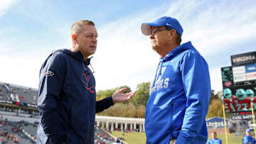Duke football head coach David Cutcliffe talks with Virginia head coach Bronco Mendenhall. (Photo by Ryan M. Kelly/Getty Images)