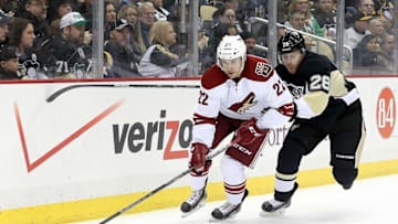 Mar 28, 2015; Pittsburgh, PA, USA; Arizona Coyotes left wing Craig Cunningham (22) skates with the puck as Pittsburgh Penguins defenseman Ian Cole (28) chases during the first period at the CONSOL Energy Center. Mandatory Credit: Charles LeClaire-USA TODAY Sports