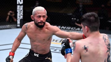 LAS VEGAS, NEVADA - DECEMBER 12: (L-R) Deiveson Figueiredo of Brazil punches Brandon Moreno of Mexico in their flyweight championship bout during the UFC 256 event at UFC APEX on December 12, 2020 in Las Vegas, Nevada. (Photo by Jeff Bottari/Zuffa LLC via Getty Images)