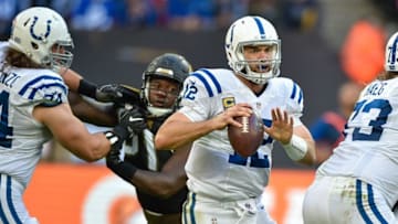 Oct 2, 2016; London, ENG; Indianapolis Colts quarterback Andrew Luck (12) works around Jacksonville Jaguars defense during the fourth quarter at Wembley Stadium. Mandatory Credit: Steve Flynn-USA TODAY Sports