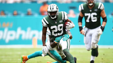 MIAMI GARDENS, FL - OCTOBER 22: Bilal Powell #29 of the New York Jets rushes against Reshad Jones #20 of the Miami Dolphins during the second quarter at Hard Rock Stadium on October 22, 2017 in Miami Gardens, Florida. (Photo by Rob Foldy/Getty Images)