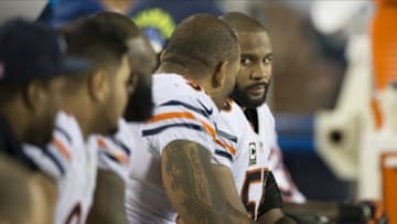 Dec 22, 2013; Philadelphia, PA, USA; Chicago Bears outside linebacker Lance Briggs (55) and defensive end Julius Peppers (90) speak on the bench during the fourth quarter at Lincoln Financial Field. Philadelphia Eagles defeated the Chicago Bears 54-11. Mandatory Credit: Tommy Gilligan-USA TODAY Sports