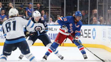Marc Staal #18 of the New York Rangers skates with the puck against Kyle Connor #81 and Patrik Laine #29 of the Winnipeg Jets