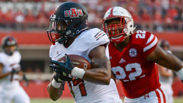 LINCOLN, NE - SEPTEMBER 02: Wide receiver Chris Murray #14 of the Arkansas State Red Wolves scores a touchdown ahead of linebacker Alex Davis #22 of the Nebraska Cornhuskers at Memorial Stadium on September 2, 2017 in Lincoln, Nebraska. (Photo by Steven Branscombe/Getty Images)
