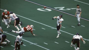 NEW ORLEANS, LA - JANUARY 26: Quarterback Jim McMahon #9 of the Chicago Bears fires a pass against the New England Patriots applies pressure in Super Bowl XX at the Superdome on January 26,1986 in New Orleans, Louisiana. The Bears defeated the Patriots 46-10. (Photo by Gin Ellis/Getty Images)