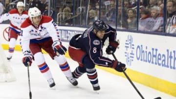 Jan 30, 2014; Columbus, OH, USA; Columbus Blue Jackets right wing Nathan Horton (8) sends the puck forward under peressure from Washington Capitals center Brooks Laich (21) at Nationwide Arena. Mandatory Credit: Greg Bartram-USA TODAY Sports