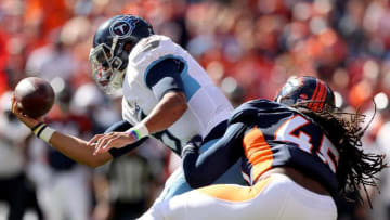 DENVER, COLORADO - OCTOBER 13: Quarterback Marcus Mariota #8 of the Tennessee Titans is sacked by Alexander Johnson #45 of the Denver Broncos in the first quarter at Broncos Stadium at Mile High on October 13, 2019 in Denver, Colorado. (Photo by Matthew Stockman/Getty Images)