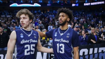 Saint Peter's Doug Edert (left) and Isiah Dasher leave the court in the second half of the Peacocks' 69-49 loss to UNC in the Elite Eight round of the NCAA tournament at the Wells Fargo Center in Philadelphia, Sunday, March 27, 2022.Ncaa Basketball Ncaa Tournament Saint Peter S Vs Unc Saint Peter S At Unc