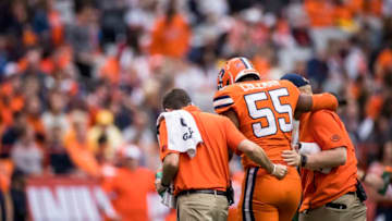 SYRACUSE, NY - NOVEMBER 02: Kendall Coleman #55 of the Syracuse Orange is helped off the field by trainers after a play in the first quarter against the Boston College Eagles at the Carrier Dome on November 2, 2019 in Syracuse, New York. Boston College defeats Syracuse 58-27. (Photo by Brett Carlsen/Getty Images)