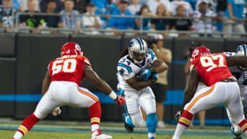 Aug 17, 2014; Charlotte, NC, USA; Carolina Panthers running back DeAngelo Williams (34) runs the ball between Kansas City Chiefs outside linebacker Justin Houston (50) and defensive end Allen Bailey (97) during the first quarter at Bank of America Stadium. Mandatory Credit: Jeremy Brevard-USA TODAY Sports