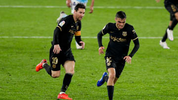 (L-R) Lionel Messi of FC Barcelona, Pedri of FC Barcelona. (Photo by David S. Bustamante/Soccrates/Getty Images)