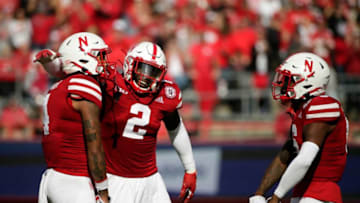 Nebraska Cornhuskers safety Myles Farmer (4), Nebraska Cornhuskers linebacker Caleb Tannor (2) and Nebraska Cornhuskers cornerback Quinton Newsome (6) celebrate after Farmer intercepted a pass during Saturday's NCAA Division I football game against the Ohio State Buckeyes at Memorial Stadium in Lincoln, Neb., on November 6, 2021.Osu21neb Bjp 884